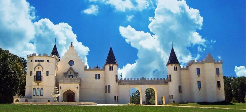 Turrets and battlements of Chateau Charmant under a blue sky
